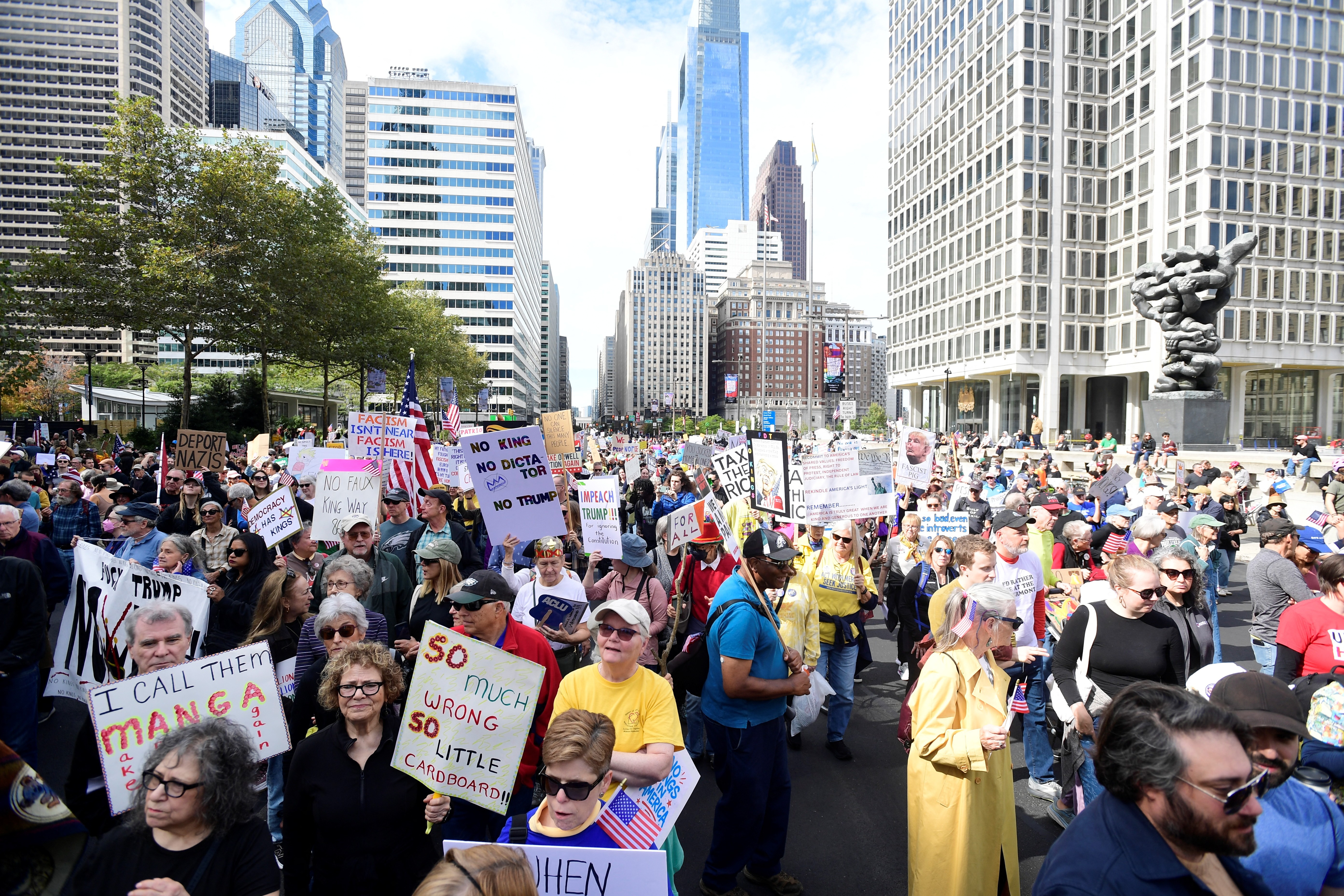 A large crowd of protesters gather in a city square in Philadelphia.