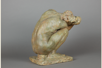 photo of sculpture of crouching woman seen from the back