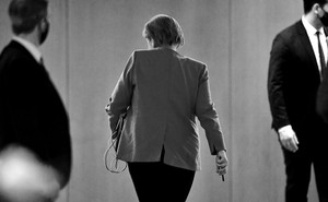 Angela Merkel walks away.