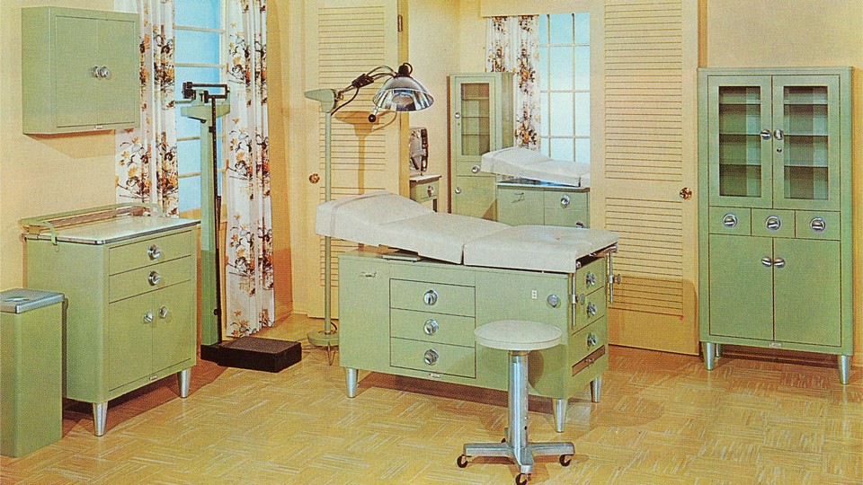 a 1960s doctor's office with yellow walls and green cabinets