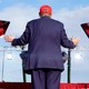Donald Trump faces away from the camera during a campaign event