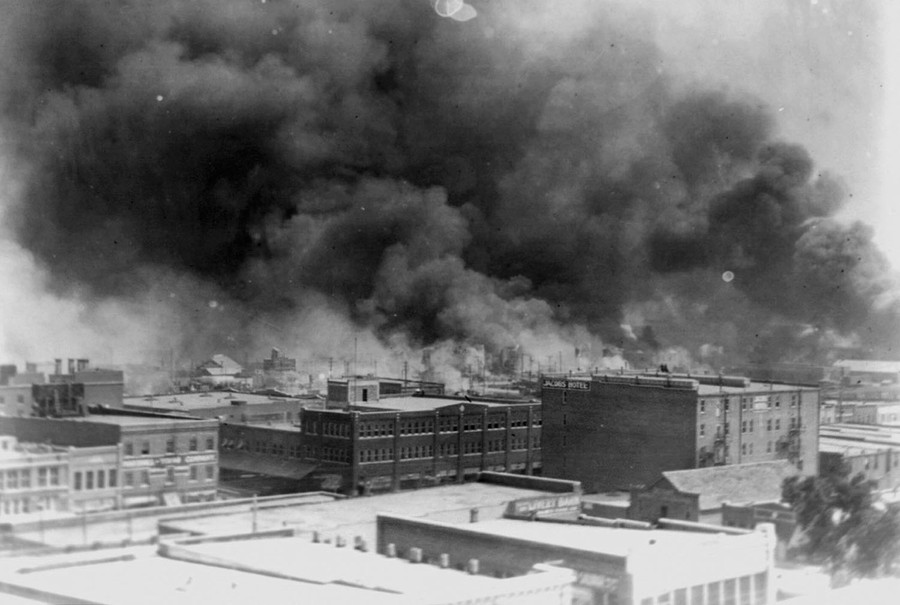 Dark smoke rises from an entire neighborhood in Tulsa.