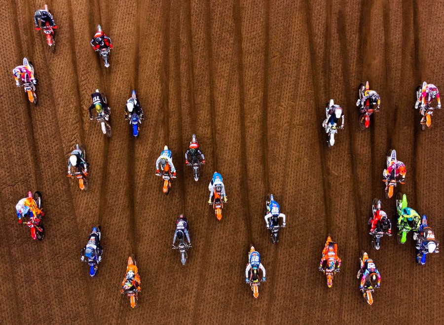 An aerial view of motorcycle riders on a dirt track