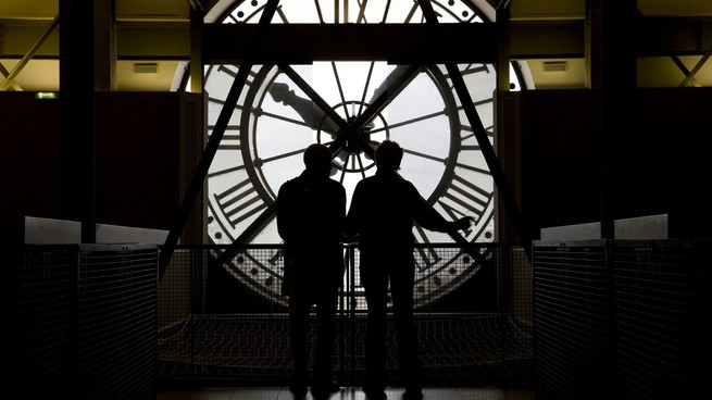People standing in front of giant clock