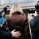 E. Jean Carroll walking into the Manhattan Federal Court building, surrounded by news photographers