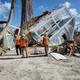 An overturned house in the aftermath of a disaster