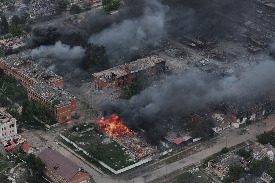 An aerial view of damaged and burning buildings