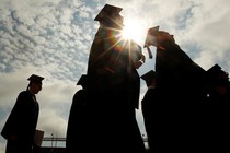 The silhouettes of several college graduates 