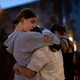 Two people embrace during a vigil after a mass shooting