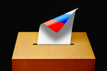 Illustration showing ballot box, with a ballot that is white on one side but the shows the Russian flag on the other side.