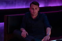 Kieran Culkin as Roman Roy in a karaoke room