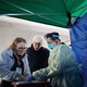 Carroll Hospital Critical Care Unit workers organize samples taken from people being tested for the coronavirus at a drive-through station in the hospital's parking garage
