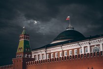 An image of the Kremlin in front of a cloudy dark night sky