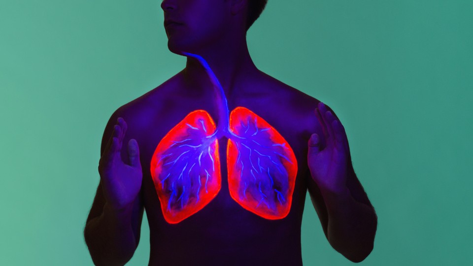 A shirtless man with his lungs highlighted in neon colors