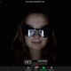 woman with Zoom screen reflected in glasses
