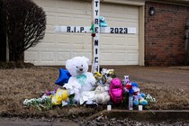 A memorial to Tyre Nichols with stuffed animals, flowers, and a cross