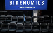Chairs sitting in rows with a Bidenomics sign above them