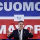 Andrew Cuomo in front of a giant "Cuomo for Mayor" sign