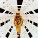 A man in a yellow spacesuit stands in a futuristic white tunnel in a scene from "2001: A Space Odyssey"