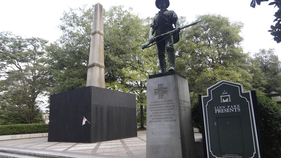 A plywood partition surrounds a Confederate monument in Birmingham, Alabama's Linn Park.