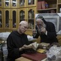 Father Columba Stewart inspects an ancient manuscript as a Syriac monk looks on at St. Mark’s Syrian Orthodox Monastery in Jerusalem.