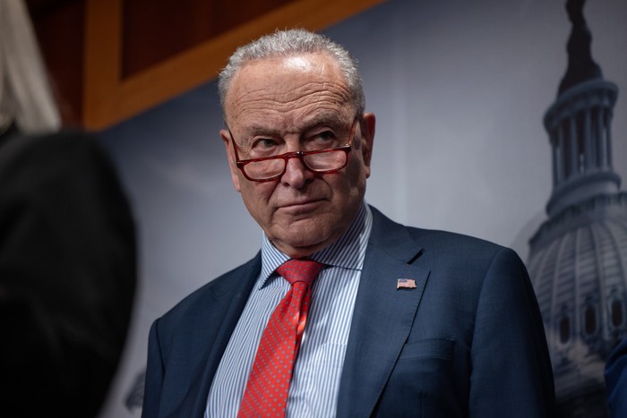 Chuck Schumer looks to the side during a press conference