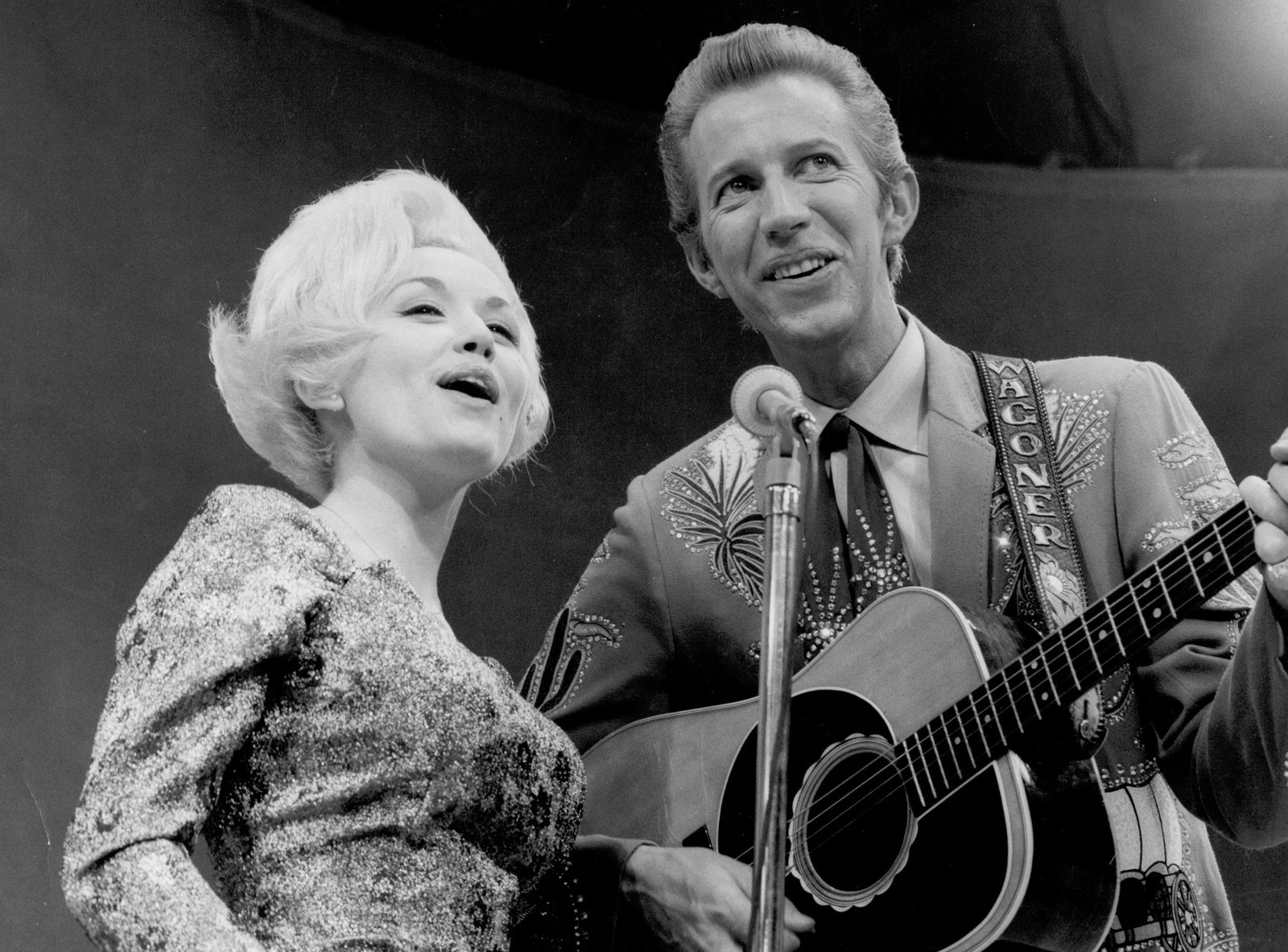 Dolly Parton and Porter Wagoner perform onstage in 1967.