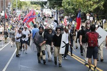 White supremacists marching in Charlottesville, Virginia, on August 12, 2017, one waving a Confederate flag