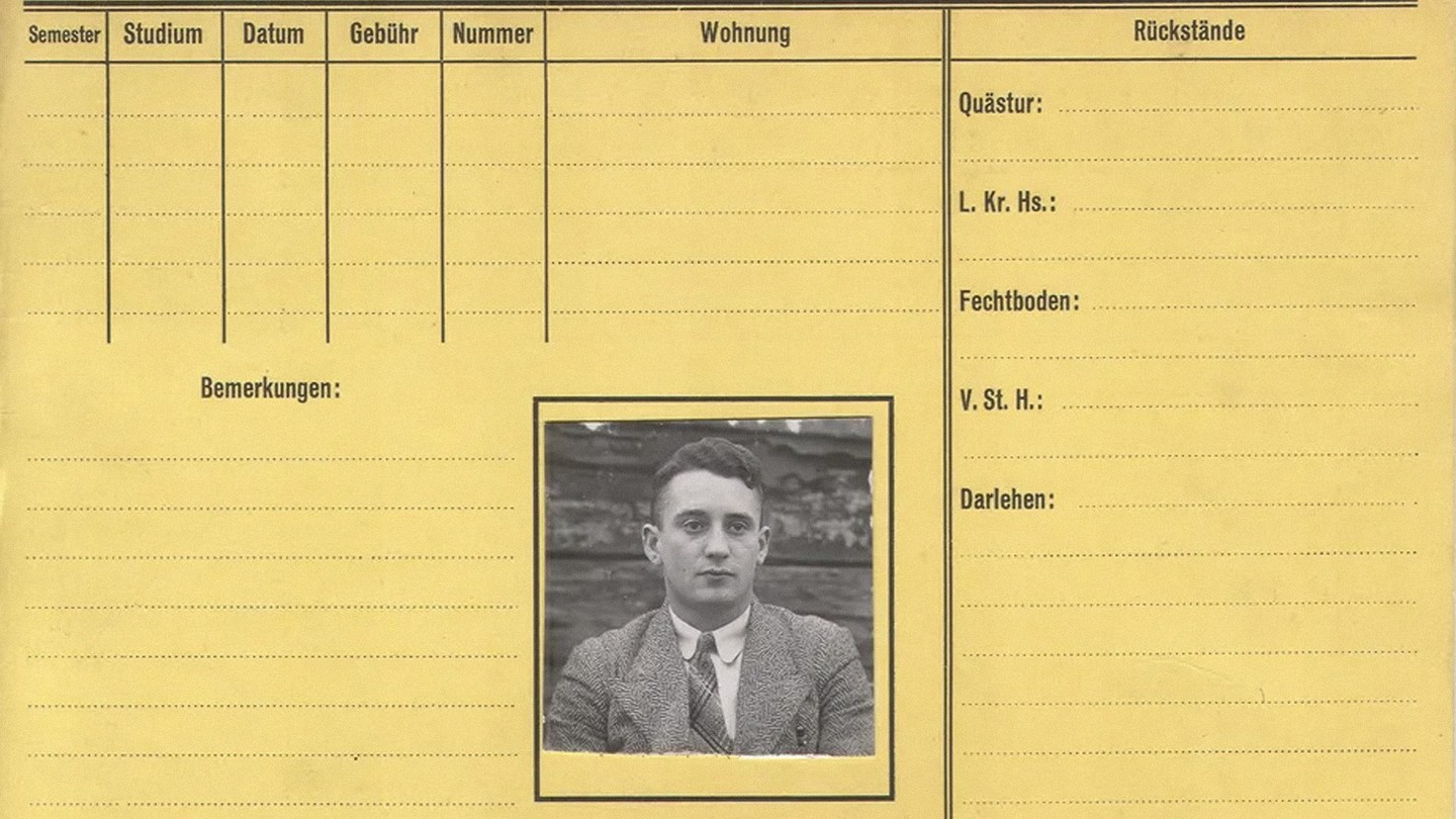 A yellow card with columns and rows titled in German, and a black and white image of a young man in a suit pasted in a square in the center