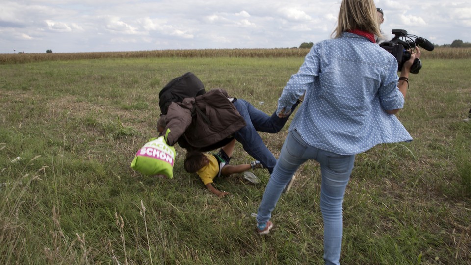 Hungarian camerawoman trips migrants