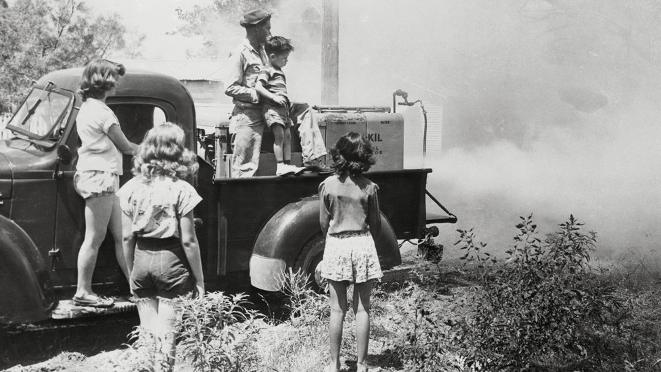 Children in San Angelo watch as DDT sprays over their community.