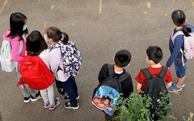 children in masks gathered at a New York elementary school