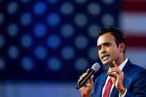 The Republican presidential hopeful Vivek Ramaswamy speaks into a microphone