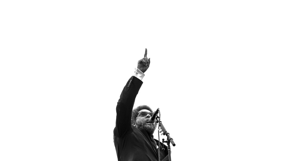 Black-and-white photo of Cornel West speaking at a microphone with his finger in the air