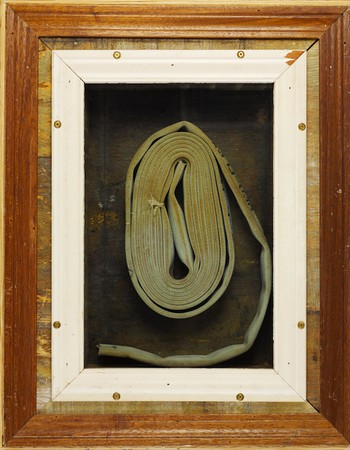 An art piece featuring a wrapped-up fire hose. 