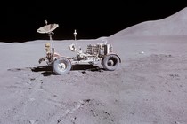 A lunar rover is seen parked on the lunar surface.