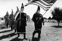 Ku Klux Klan members march in cemetery funeral rites in Chesapeake, Virginia, in 1966.