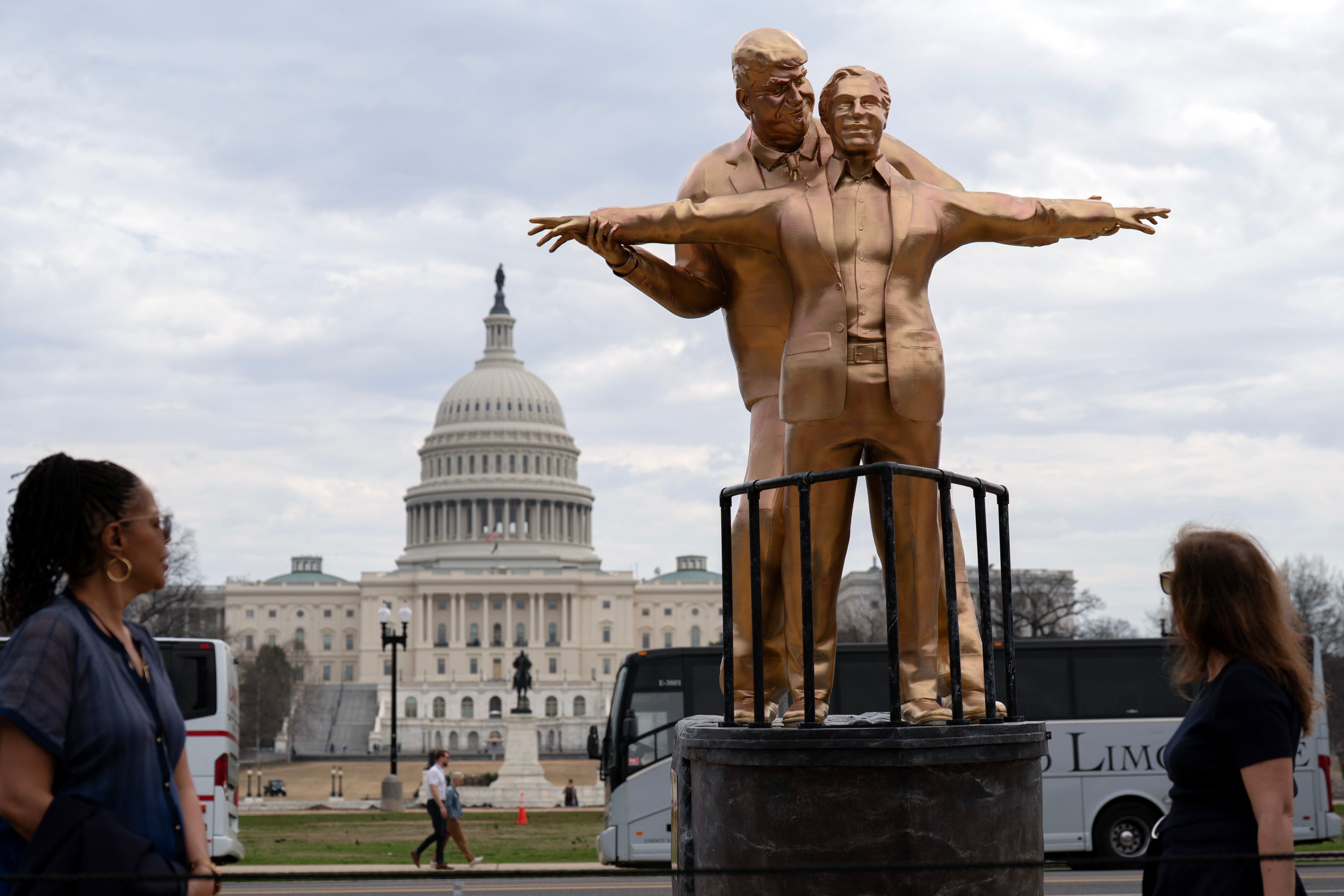 An odd-looking golden statue, depicting Donald Trump and Jeffery Epstein posing like Jack and Rose on the bow of the Titanic.