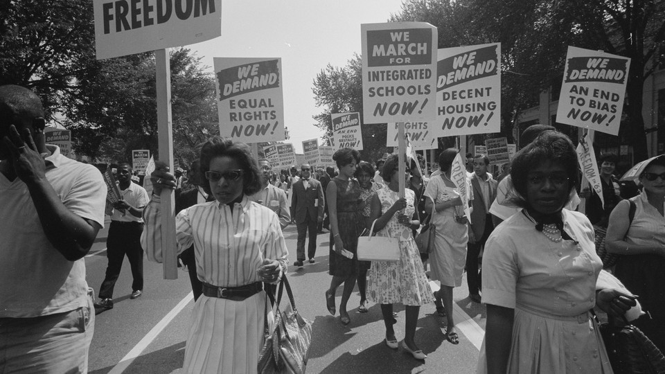 A black and white photo featuring African Americans holding signs that read "We demand equal rights now!" "We march for integrated schools now!" and "We demand decent housing now!"