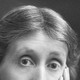 A black and white photograph portrait of Virginia Woolf in older age, cropped to just above her nose, showing her furrowed brow