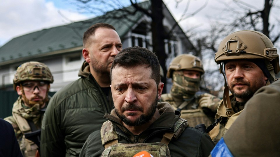 Ukrainian President Volodymyr Zelensky, in combat gear, speaks to the press in the town of Bucha