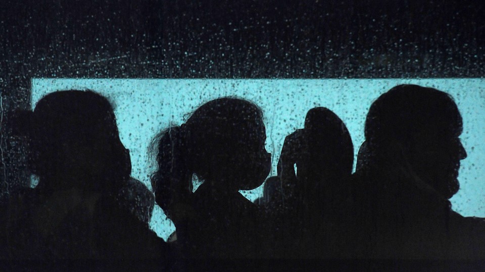 silhouettes of refugees on a bus