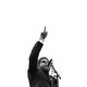 Black-and-white photo of Cornel West speaking at a microphone with his finger in the air