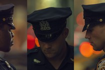 A triptych of portraits of police officers in uniform. The first looks away from the camera; the second and the third look down.