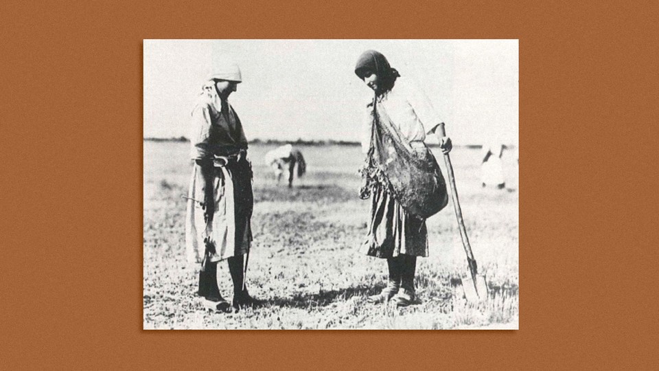 Two women standing with shovel