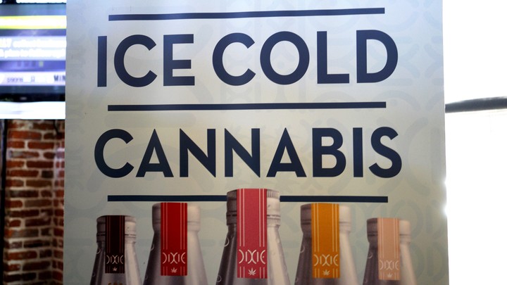 A banner hangs at the Dixie Elixirs company booth at the CannaSearch cannabis-industry job fair in downtown Denver on September 16, 2014.