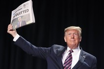 Trump displays a newspaper reading, "Acquitted"