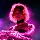 The late electronic producer Sophie bathed in pink light