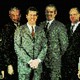 Pixelated photo of six men wearing a suit and smiling for the camera