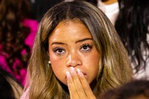 Black woman at an election watch party looking nervous